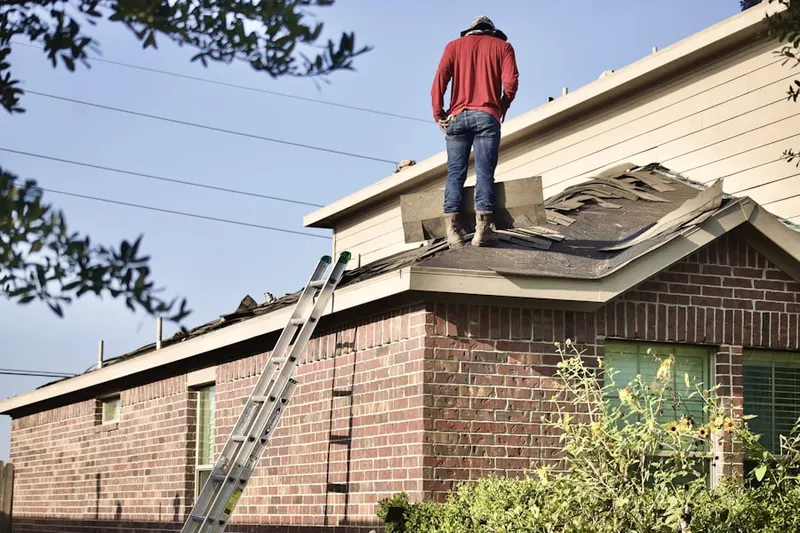 Professional roofer working on a residential roof in Olde Torrance